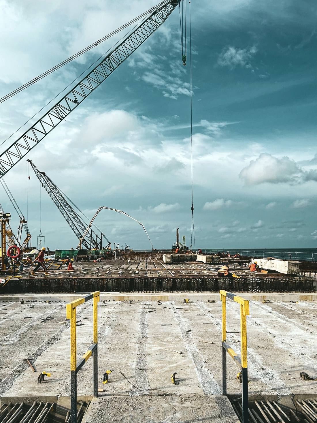 Cranes over a coastal infrastructure construction site