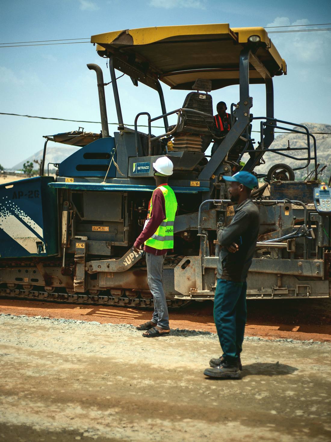 Road crew working alongside an asphalt paver